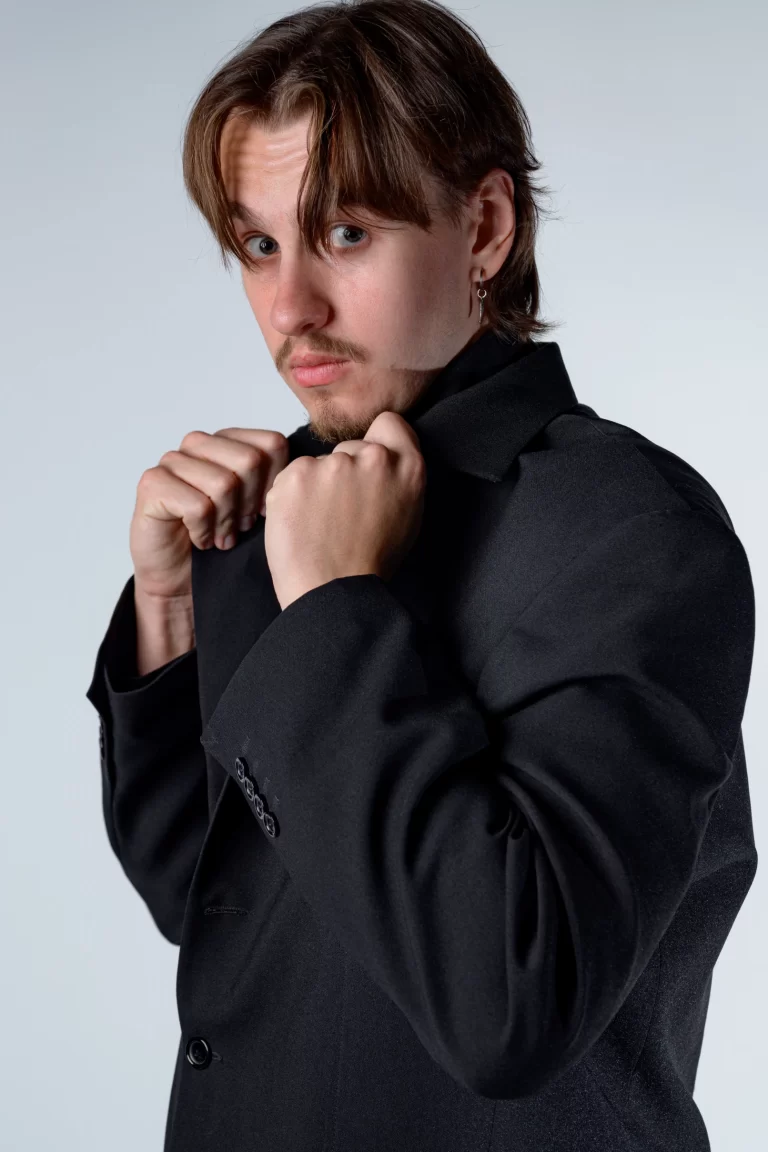 A modern, high-fashion studio portrait of Amar Galešić in an all-black outfit by Sinisa Zec Studio